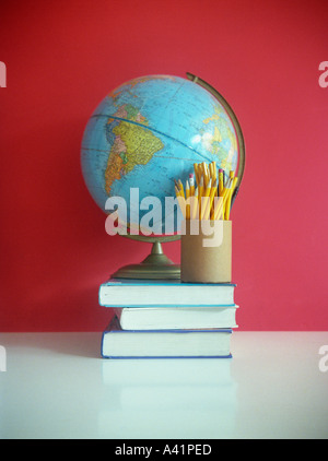 Still life of books pencils and globe Stock Photo