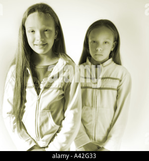 Twin sisters one happy the other sad age 10 Stock Photo