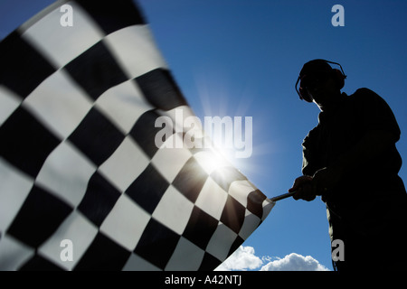 man waving checkered flag model released low angle Stock Photo