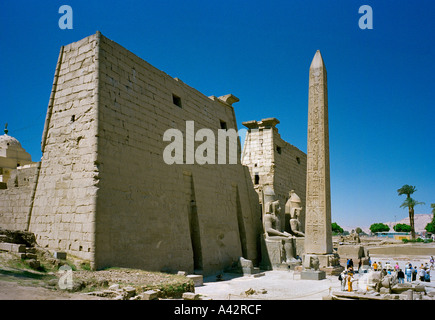 The magnificent Temple of Luxor with colossal statues of Ramses ll and an obelisk in front of the entrance pylons Stock Photo