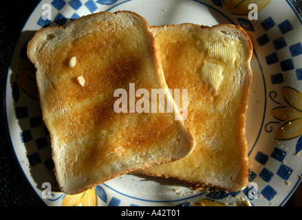 Butter melting on hot toast. Stock Photo
