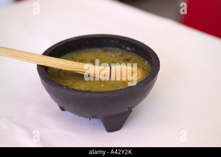 Bowl of green salsa verde picante condiment on a restaurant table in Mexico City Stock Photo