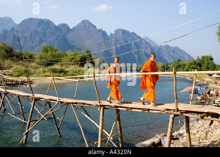 Monk and Novice Crossing a Bamboo Bridge Song River Vang Vieng Laos