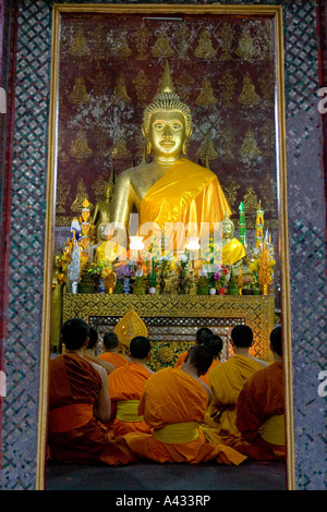 Monks and Novices at Prayer Wat Xieng Muan Luang Prabang Laos Stock Photo