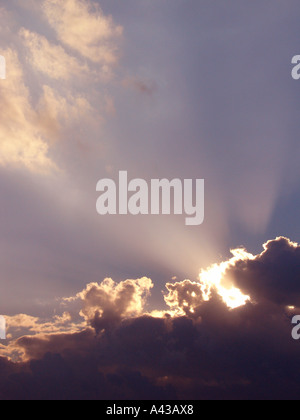Dramatic shafts of sunbeams breaking through clouds Stock Photo