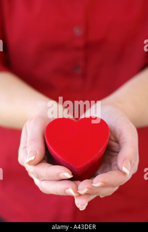 Woman holding heart shaped box Stock Photo