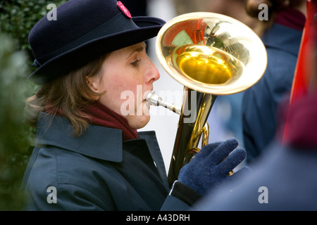 salvation army volunteer playing horn on the street Stock Photo