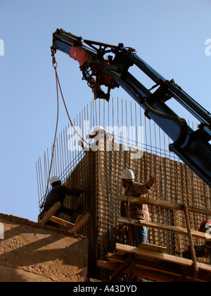 Workers attach reinforcing steel rods at a construction site in Tel Aviv Israel Stock Photo