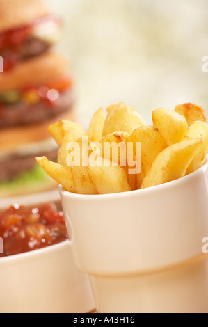 TRIPLE BEEF BURGER WITH CHEESE RELISH PICKLE SALAD ONION RELISH AND CHIPS Stock Photo