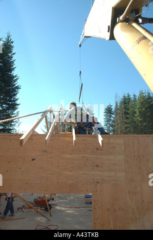 Worker are installing metal framing wooden beams in building under ...