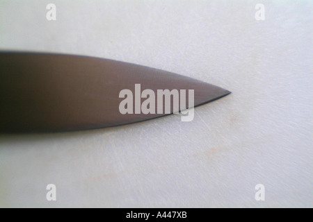 Edge of a Knife on a cutting board Stock Photo
