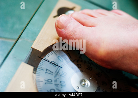 250 pound 120kg man weighs himself on bathroom scales Stock Photo