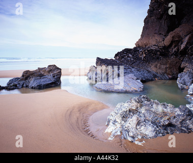 Rocks and tide pool at Bedruthan Beach Cornwall England March 2005 Stock Photo