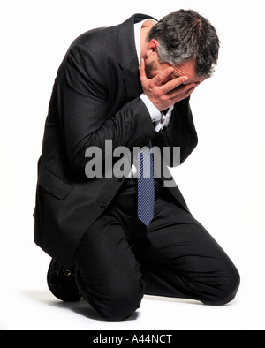 An emotional man sits holding his head with his hands. Picture by Patrick Steel patricksteel. Stock Photo