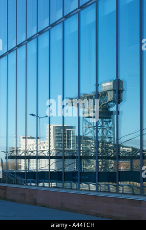 Finnieston Crane reflected in the glass windows of the BBC Scotland HQ building, Pacific Quay, Glasgow, Scotland Stock Photo