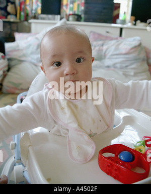 A six-month-old mixed race Caucasian-Chinese baby boy playing at home. Stock Photo