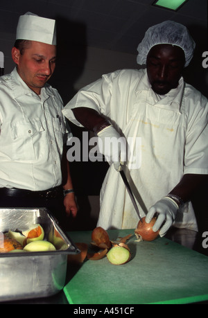 Inmate working in the kitchen. Correctional Officer supervising ...