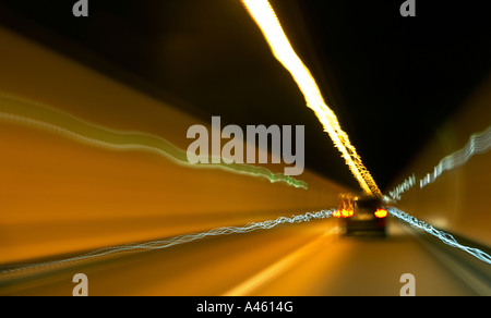 Blurry photo of a car driving through a tunnel Stock Photo