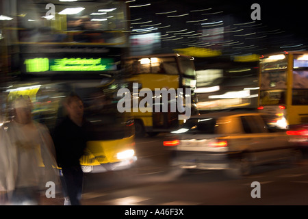 Blurred photo of pedestrians and buses in the street, Berlin, Germany Stock Photo