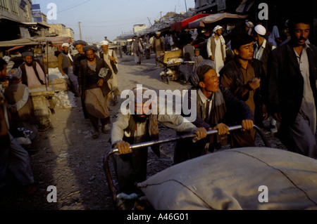 Men push a cart in the Bazaar,  Mazar i Sharif, Afghanistan Stock Photo