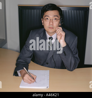 Businessman using telephone headset Stock Photo