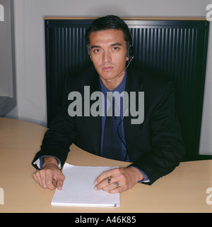 Businessman using a telephone headset Stock Photo
