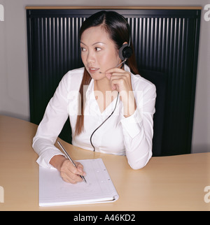 Businesswoman wearing a telephone headset Stock Photo