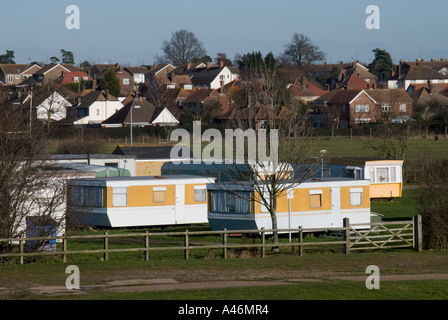 Burnham On Crouch caravan holiday homes positioned just behind the sea wall and in front of residential area Stock Photo