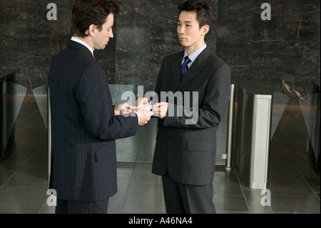 Businessmen exchanging business cards Stock Photo