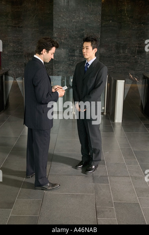 Businessmen exchanging business cards Stock Photo