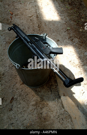 Rifle on a bucket full of ammunition Stock Photo