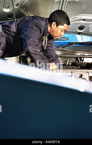 Mechanic working on engine Stock Photo