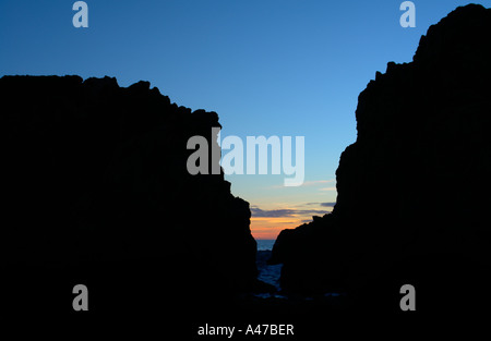 Sunset through a rock fissure at Big Sur, California, United States Stock Photo