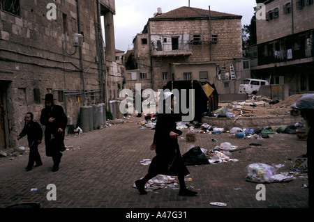 An Orthodox Jewish man and boys in the ultra orthodox ghetto of Meir Sharim Jerusalem Israel Stock Photo