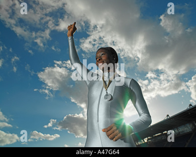 Female athlete wearing medal Stock Photo