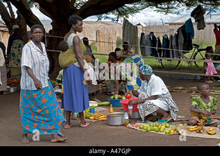 Local women buying and selling fruit in market of remote fishing village, Lake Albert, Northern Uganda, East Africa Stock Photo