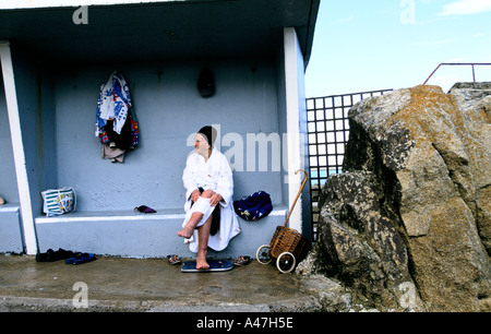 A woman after a swim in the forty foot bathing hole at Sandycove used daily by coldwater swimmers Stock Photo