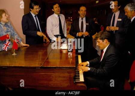 Russian Businesspeople having a sing song after dinner and drinks during a cultural exchange visit between the UK and Russia Stock Photo
