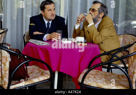 two men discussing the future of montenegro over a coffee and cigarette on terrace of hotel cerna gora podgoriza Stock Photo