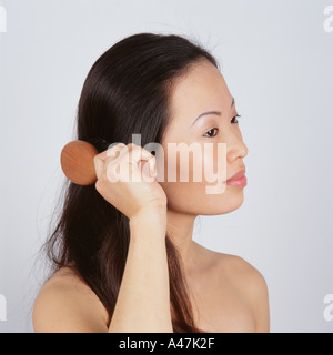 Asian woman brushing hair Stock Photo