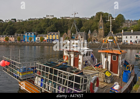 Boat with lobster pots at harbour pier with view across to Tobermory town, Isle of Mull, Argyll and Bute, Scotland, UK