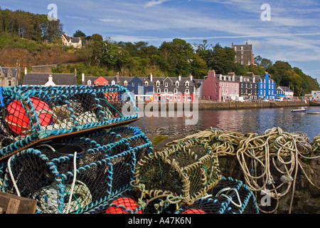 Lobster pots on harbour pier with view across to Tobermory town, Isle of Mull, Argyll and Bute, Scotland, UK