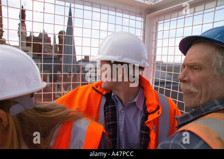 Construction workers in lift Stock Photo