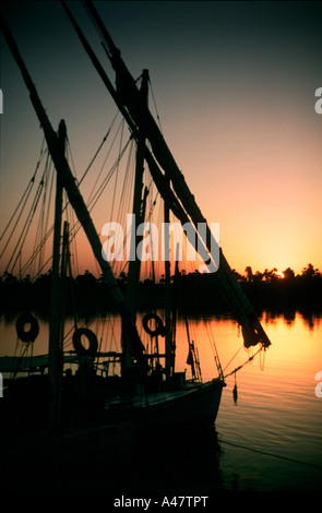 Two feluccas silhouetted against a sunset on the Nile in Egypt Stock Photo