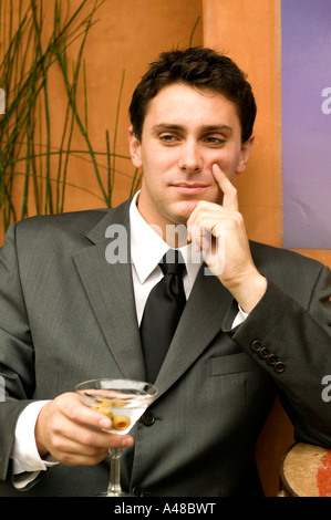 Businessman holding drink, smiling Stock Photo