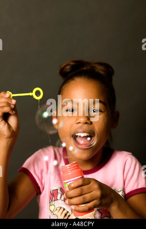 Studio portrait of girl blowing bubble gum Stock Photo - Alamy