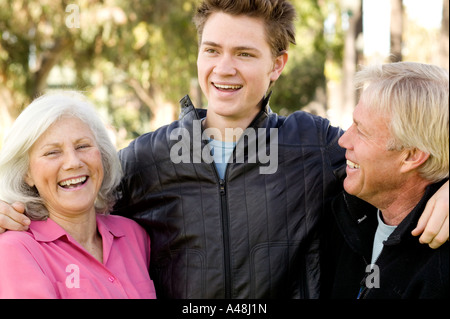 Grandson standing with grandparents Stock Photo