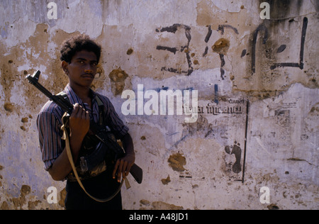 tamil tiger soldier posing with his kalashnikov in front of a wall a48jd1