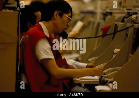 trader speaking on telephone in the hang seng index stock exchange in hong kong