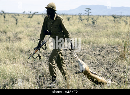 Sudan peoples liberation army soldier with a dead antelope after a hunting expedition Stock Photo